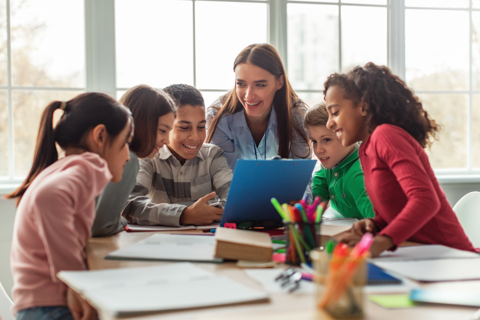 Teacher with elementary students in classroom